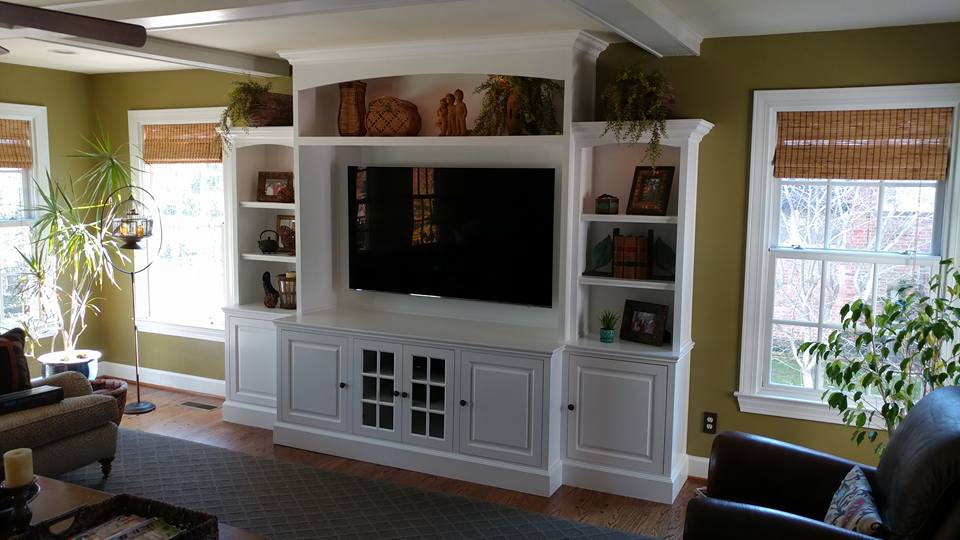 custom built-in entertainment center in Louisville, Kentucky by Ryan featuring sprayed white lacquer finish, raised panel doors on soft-close hinges, dimmable touch lighting, adjustable shelving and decorative moldings