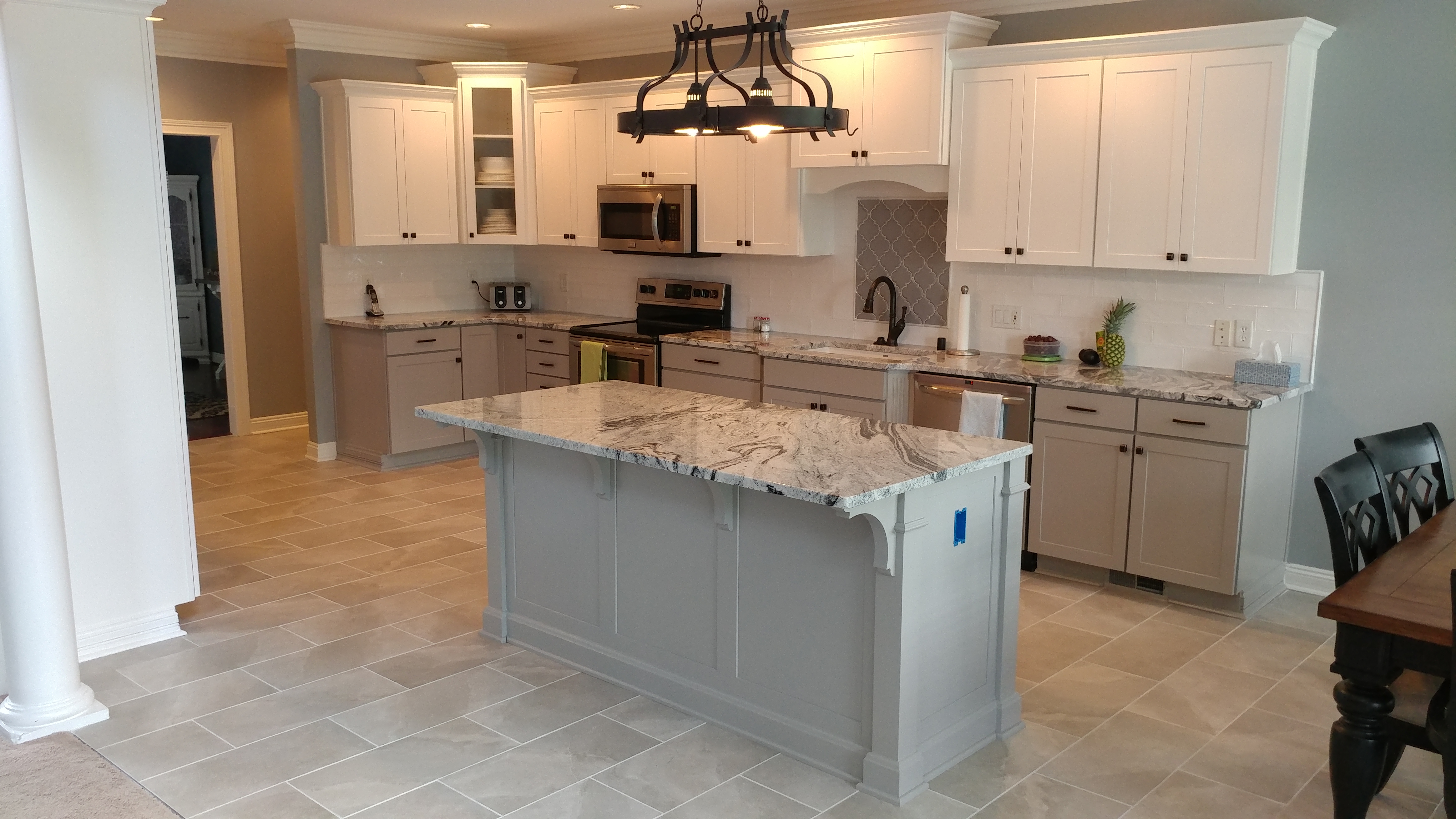 Final out of Kitchen Remodel in Glenmary Subdivision in Louisville, KY by Ryan Bruzan.  Features new Shaker doors with concealed, soft-close hinges; lacquer painted cabinets; a new custom island; new tile backsplash and granite countertops.